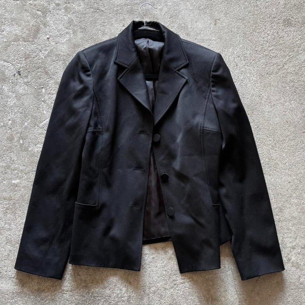 Black minimalist blazer with button closure and shoulder pads